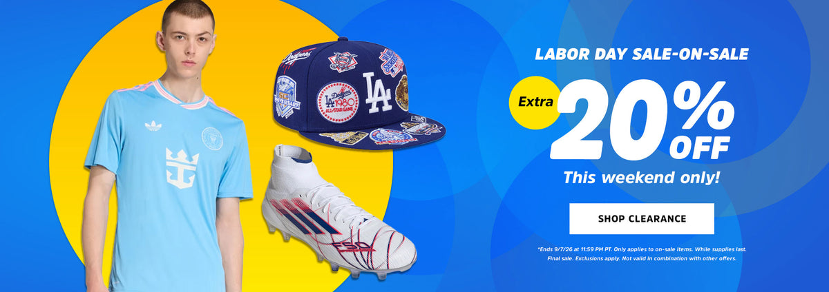 A promotional banner for a Labor Day sale featuring a young man in a light blue soccer jersey, a navy blue LA baseball cap, and a white soccer cleat, alongside large sale text on a blue and yellow graphic background.