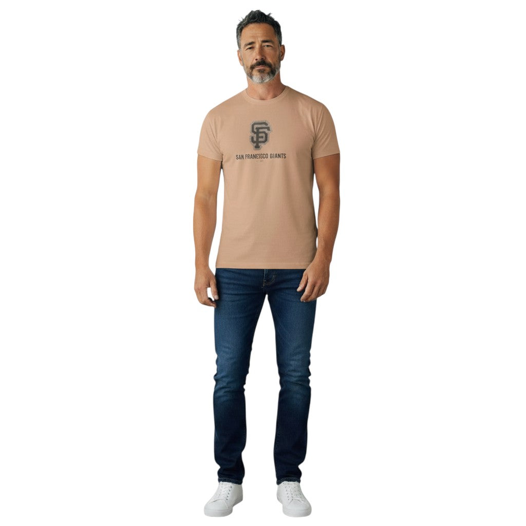 Coliseum Sports Nike San Francisco Giants hemp blend t-shirt in tan worn by a man with dark blue jeans
