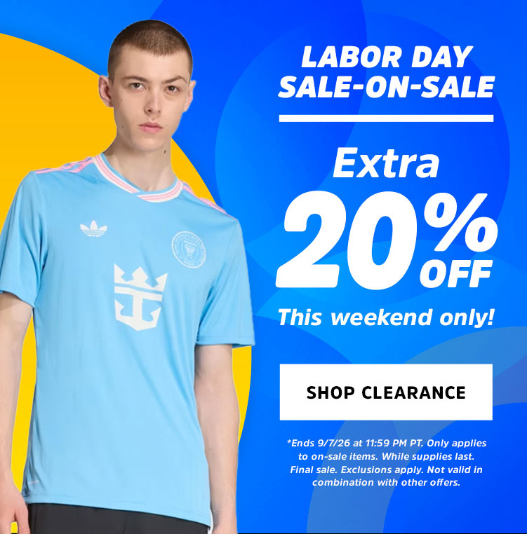 A male model wearing a light blue Adidas soccer jersey with a crown crest and Adidas logo, set against a vibrant blue and yellow graphic background with a 'Labor Day Sale-On-Sale Extra 20% Off' promotional text.