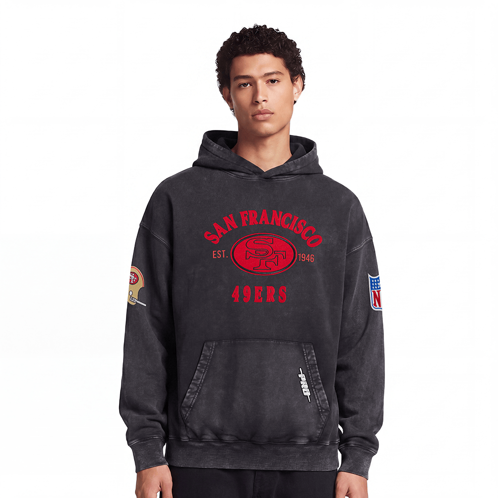 Pro Standard Men's San Francisco 49ers First Team Enzyme Wash Drop Shoulder French Terry Pullover Hoodie - Washed Black, model front view