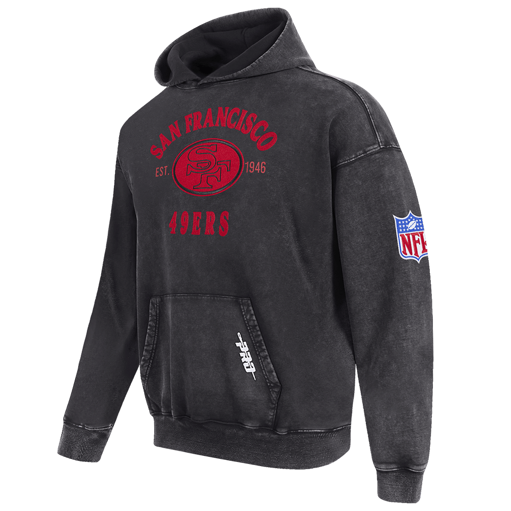 Pro Standard Men's San Francisco 49ers First Team Enzyme Wash Drop Shoulder French Terry Pullover Hoodie - Washed Black, angled front view